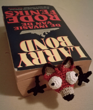 crochet bookmark made to look like a squashed fox body and full head with bulging eyes
